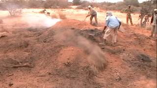 The fire is buried in sand to let the charcoal smoulder